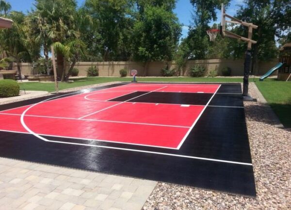 A tennis court with red and black markings.