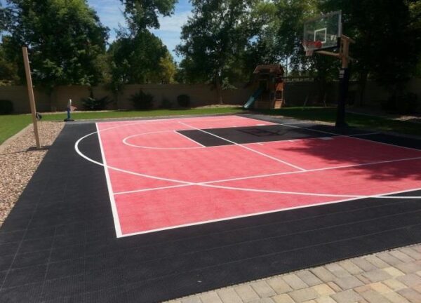 A basketball court with red and black markings.