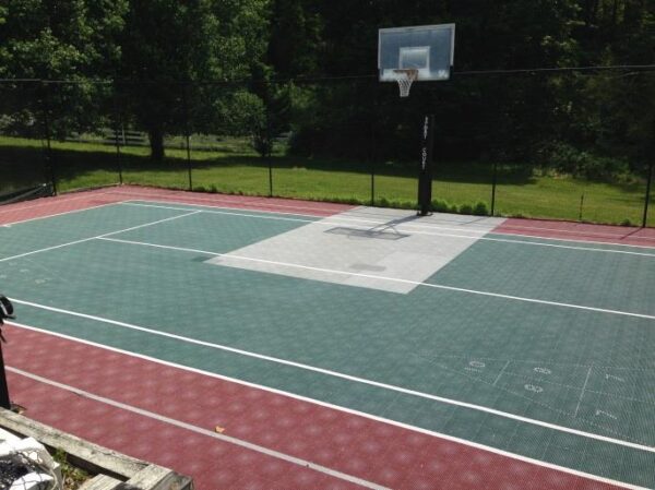 A basketball court with a net and basket ball hoop.